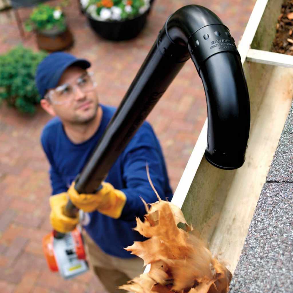 man cleaning a gutter in guildford